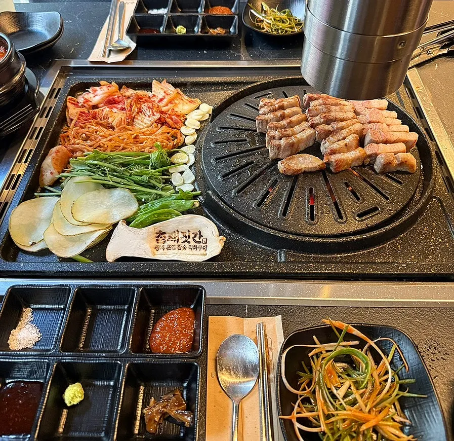 A pan piled high with pork belly and vegetables
