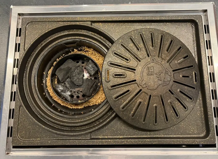Cham Dwaejitgan's grill plate that lets oil drip down
