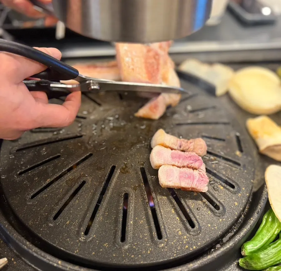 Staff grilling pork belly on the plate
