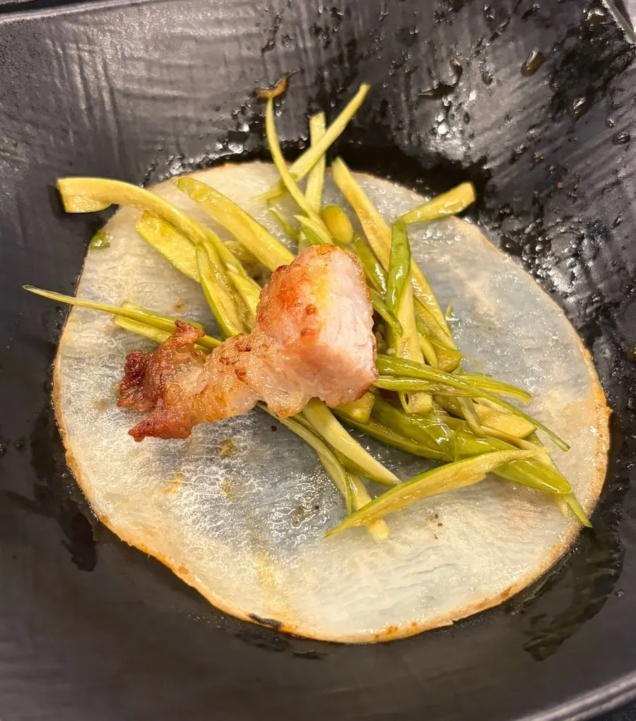 Potato slice wrap topped with garlic scapes and mushroom wasabi