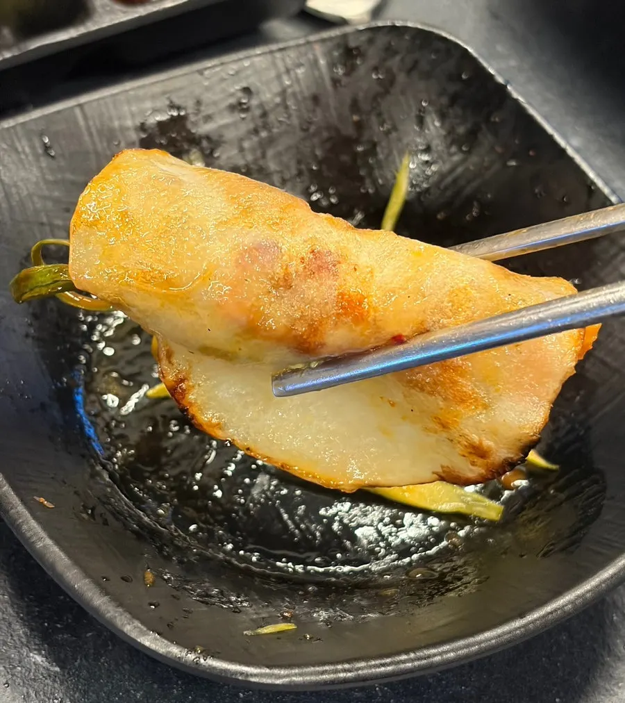 Pork belly rolled up in a potato slice wrap