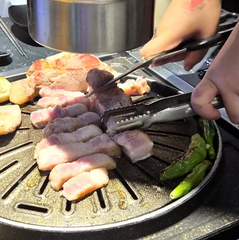 Black pork belly grilled with the skin pressed down