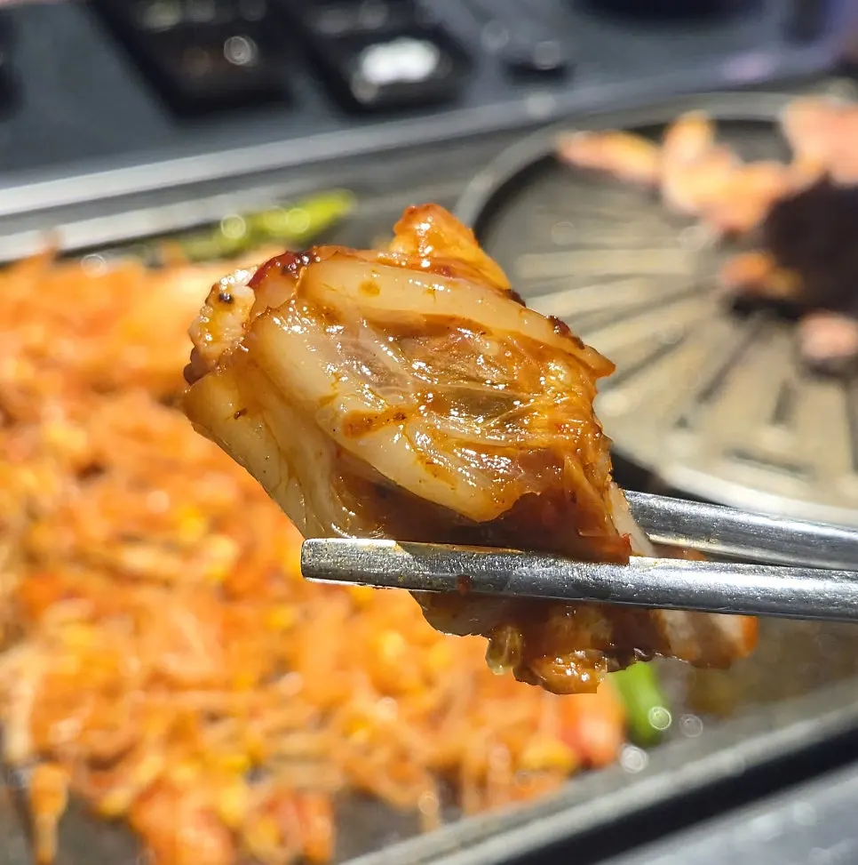 A piece of meat dipped in spicy sauce
