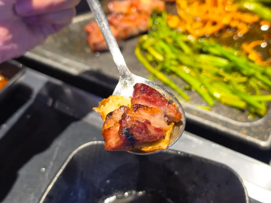 Grilled meat picked up together with minari