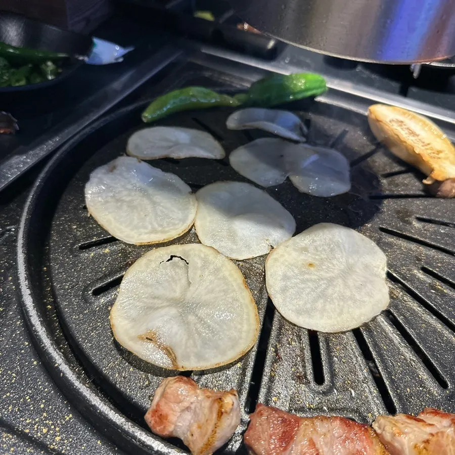 Pork belly wrapped with grilled sliced potato
