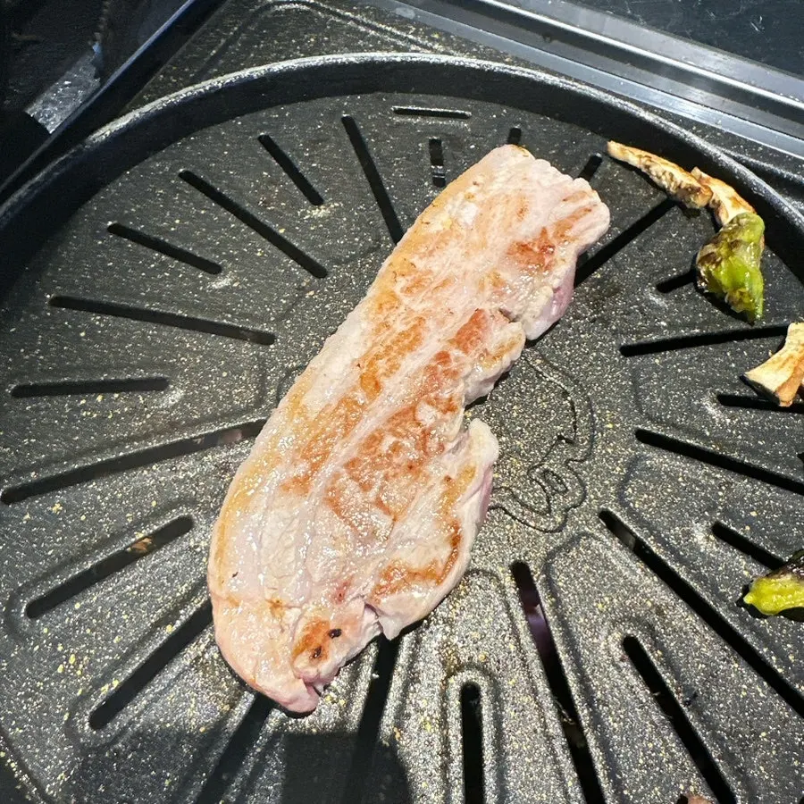 The extra serving of pork belly and minari that was ordered