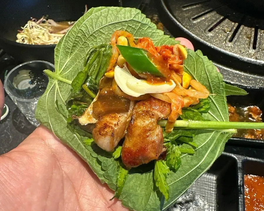 A generous lettuce wrap filled with pork belly