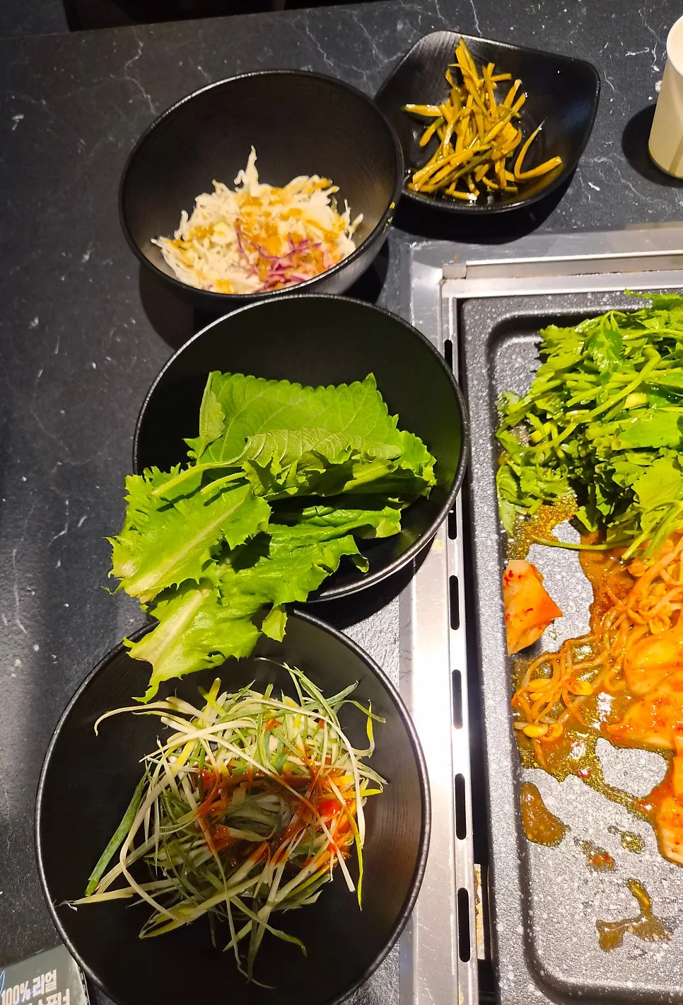 A plate of Cham Dwaejitgan's scallion salad side dish