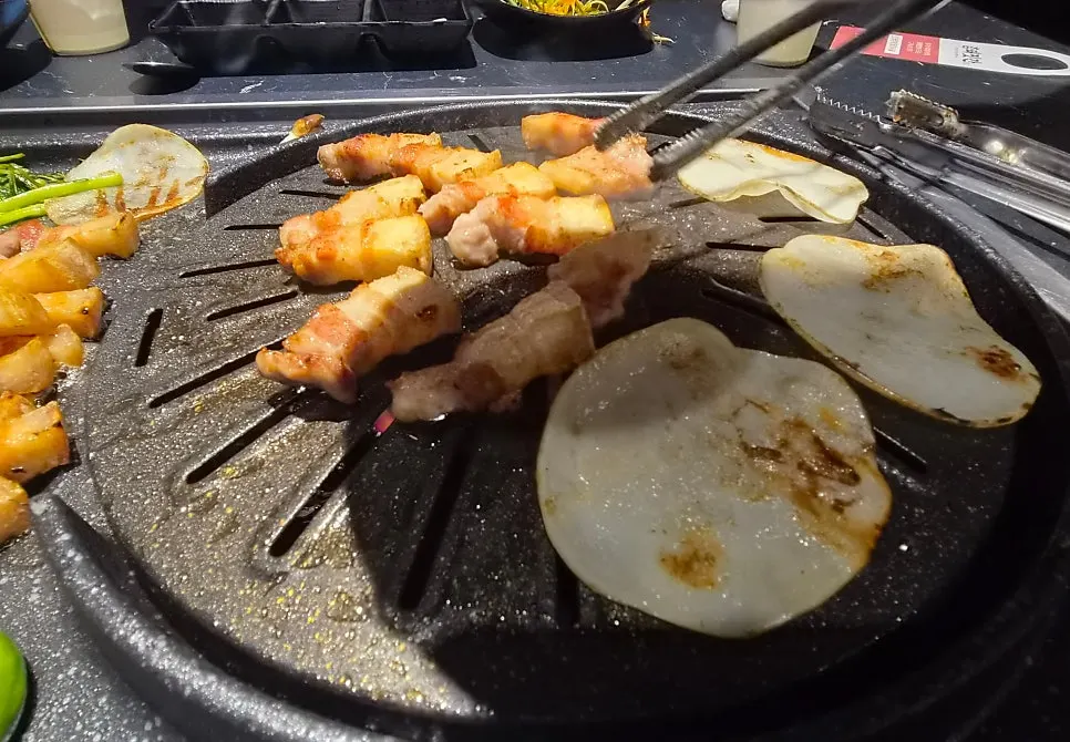 Thin potato slices placed on the grill