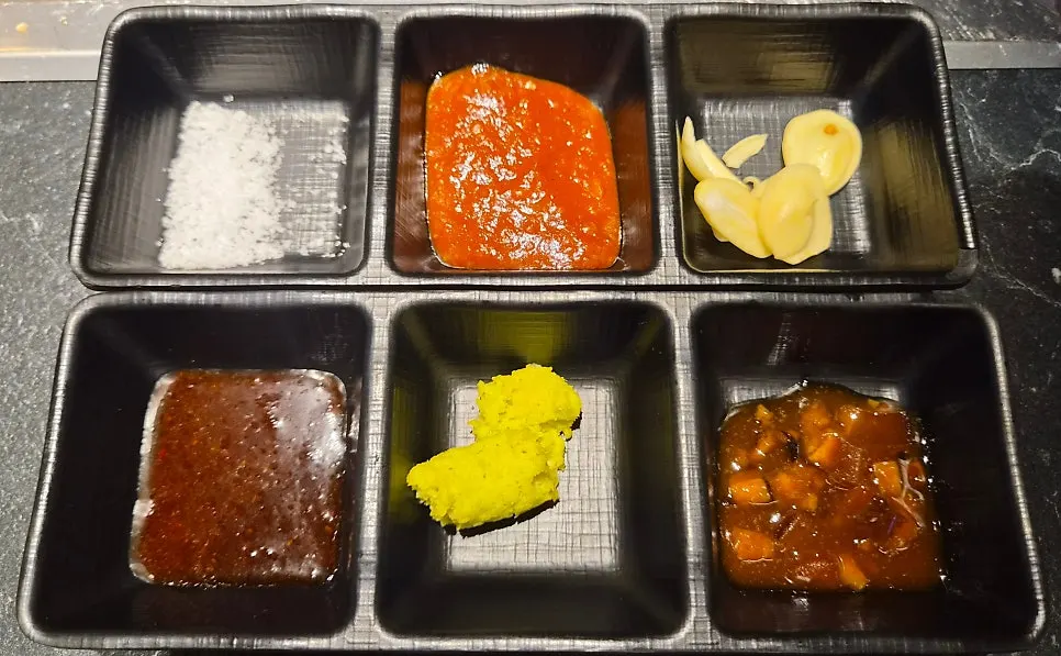 Salt, ssamjang and wasabi sauces set out on the table