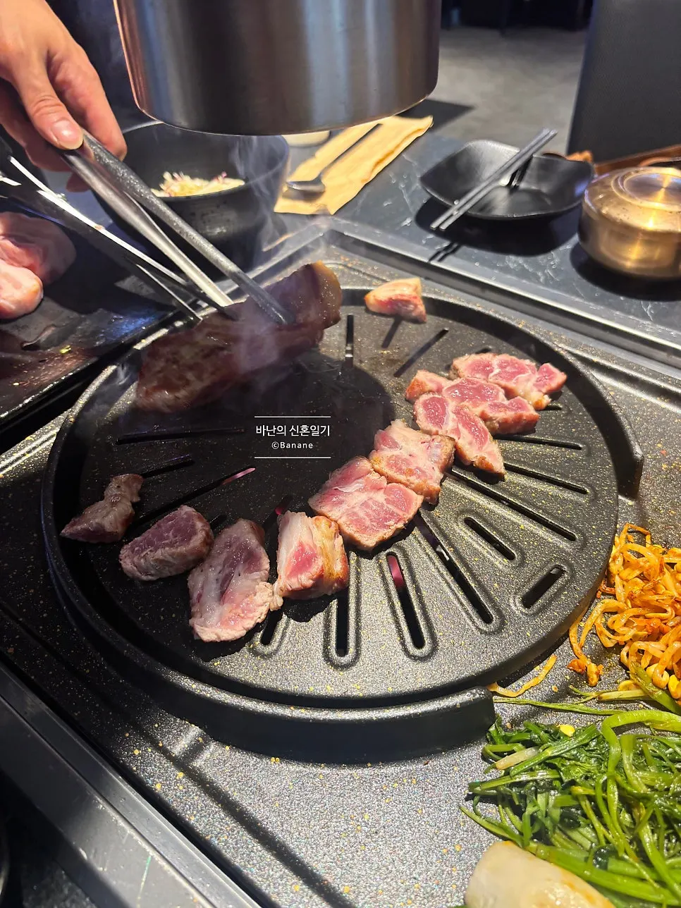 지리산 강쇠주 병과 함께 차려진 고깃집 테이블