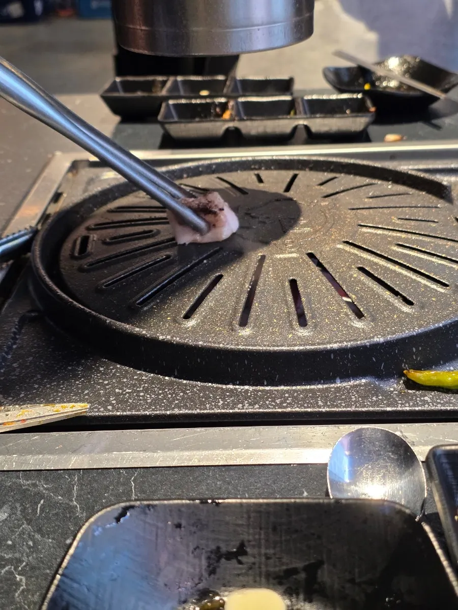 Oiling the grill with pork fat before cooking