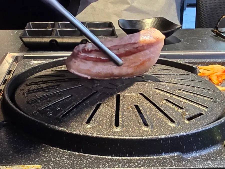Black pork belly turning crispy on the outside