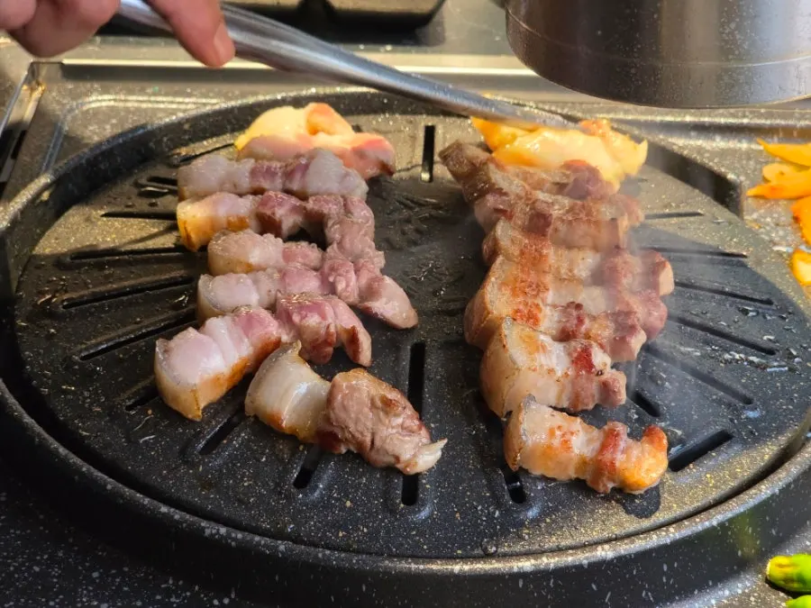 Staff cutting the meat into bite-size pieces