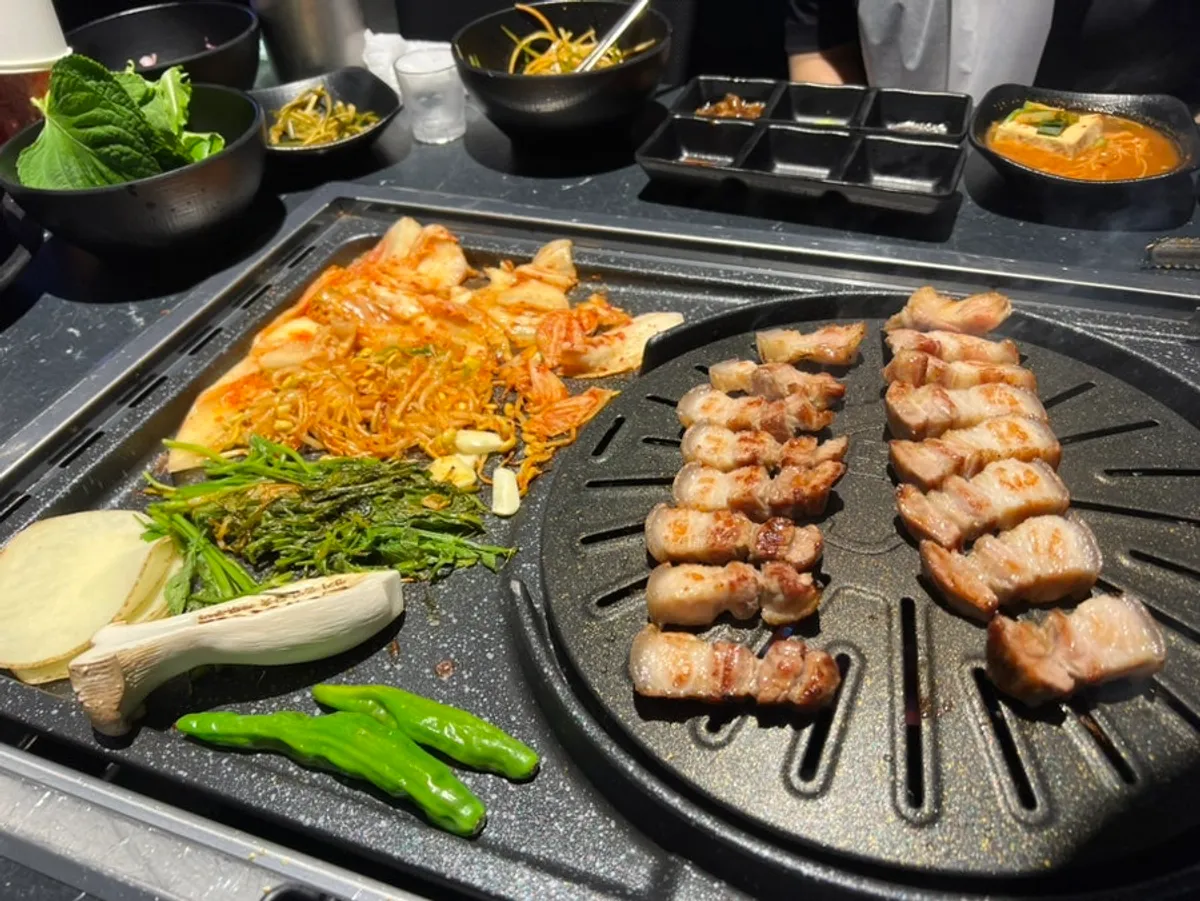 Crispy grilled potato slices next to ogyeopsal