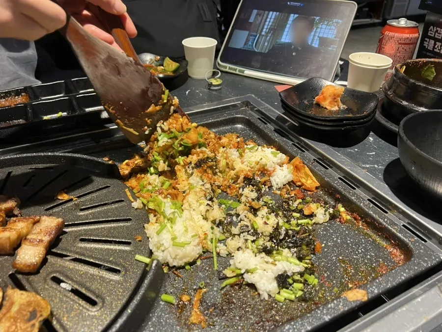 Fully cooked meat gathered to one side along with minari