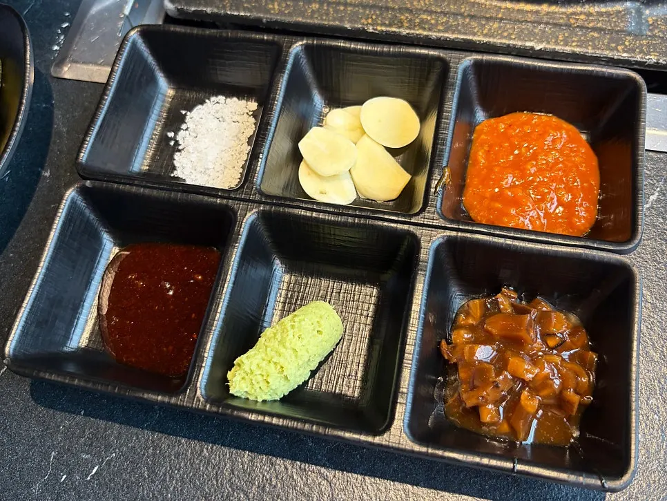 Sauce setup with salt, garlic, ssamjang, and mushroom wasabi