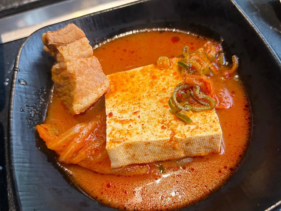 A pot of kimchi jjigae simmering