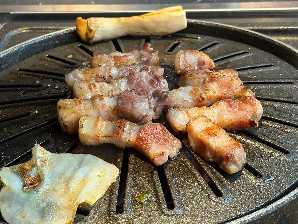 Pork belly cooking on the grill