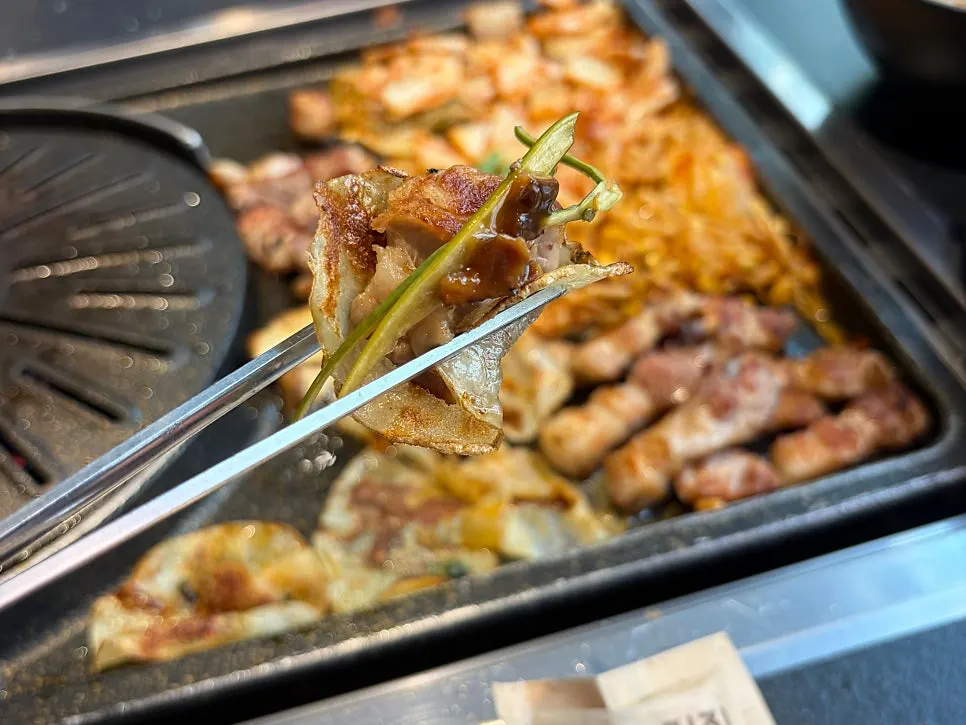 Potato wrap topped with meat, garlic scapes, and mushroom wasabi