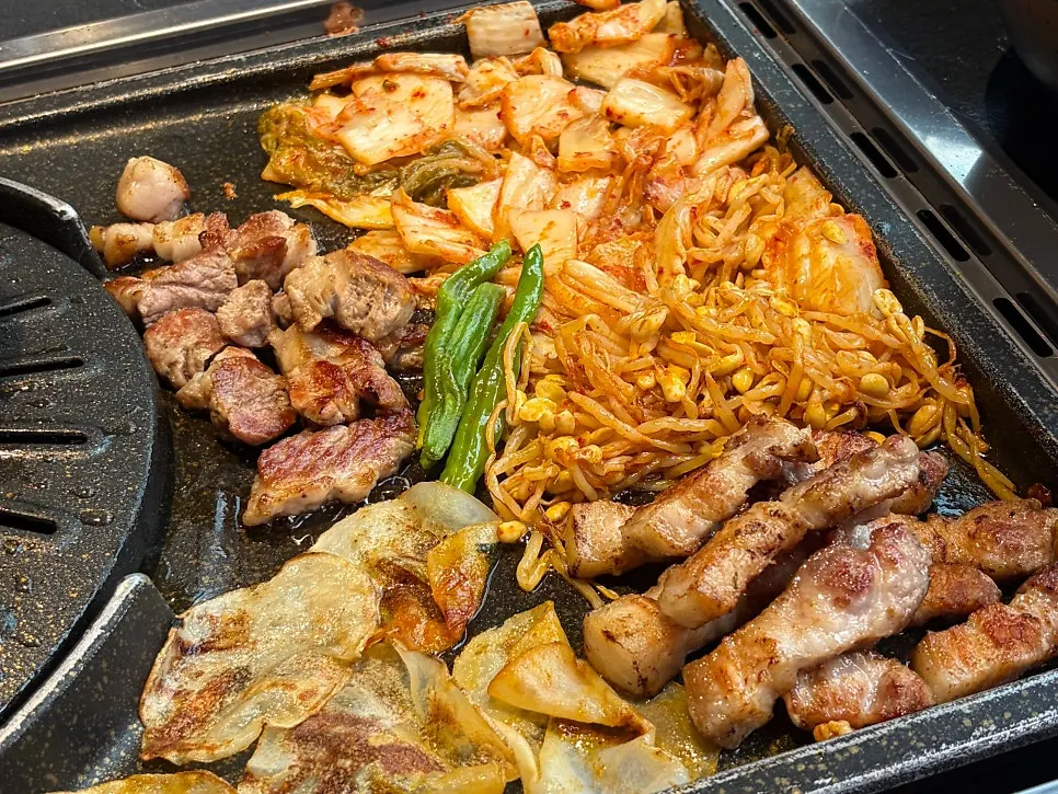 A grill full of meat and vegetables