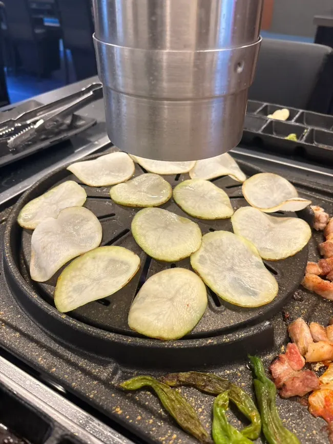 A grill piled high with an extra order of potato slices
