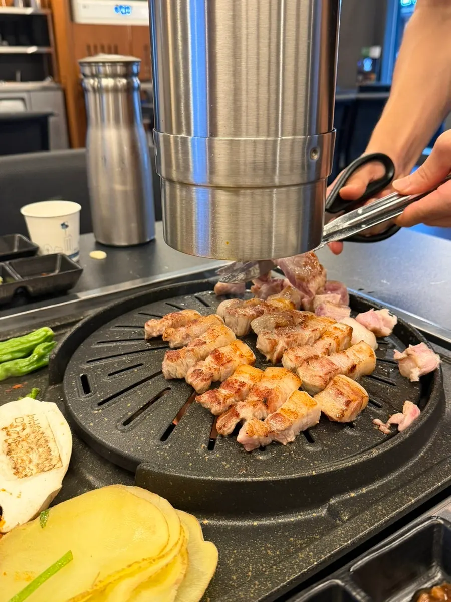 Pork neck cooking on the grill
