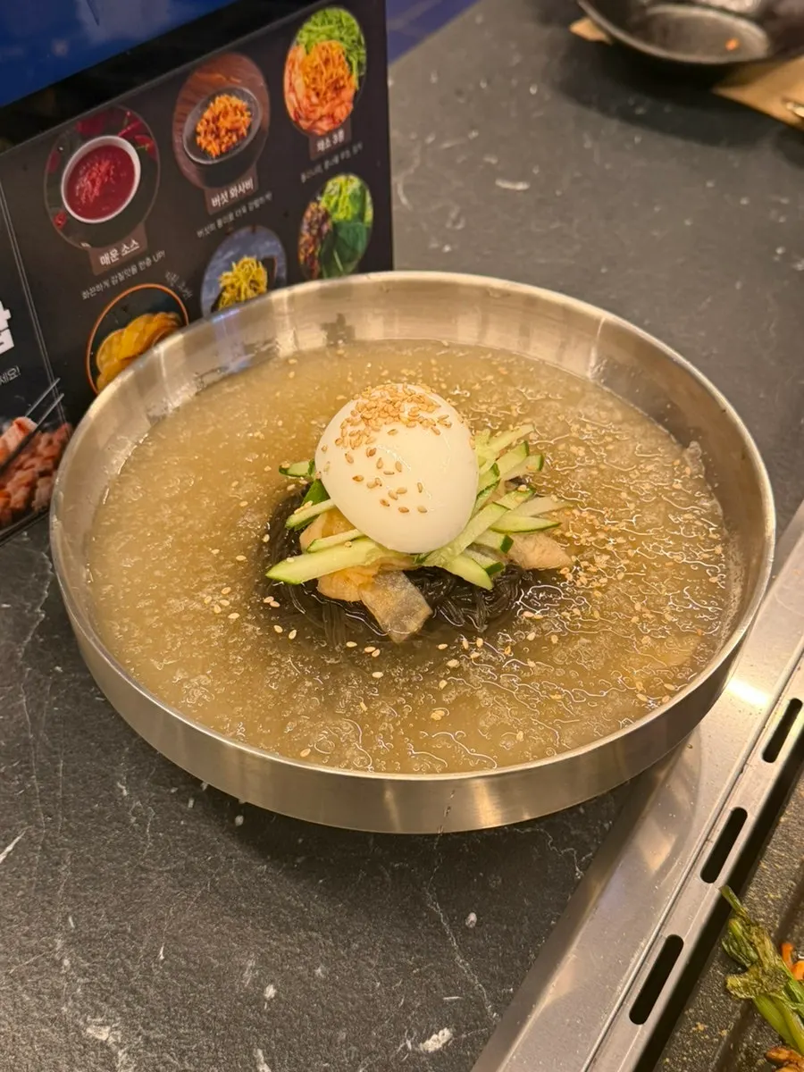 A bowl of mul-naengmyeon with ice slush