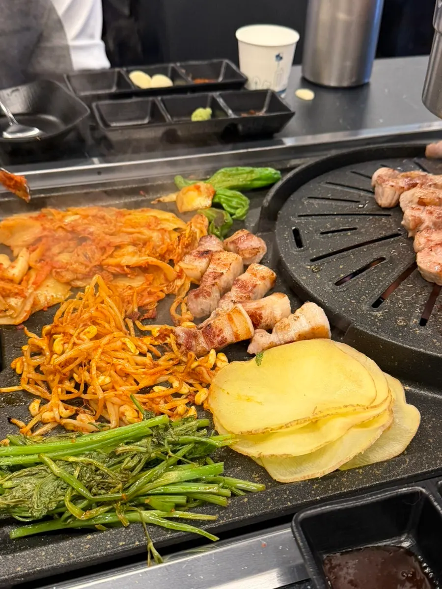 A wrap of pork belly with minari and potato