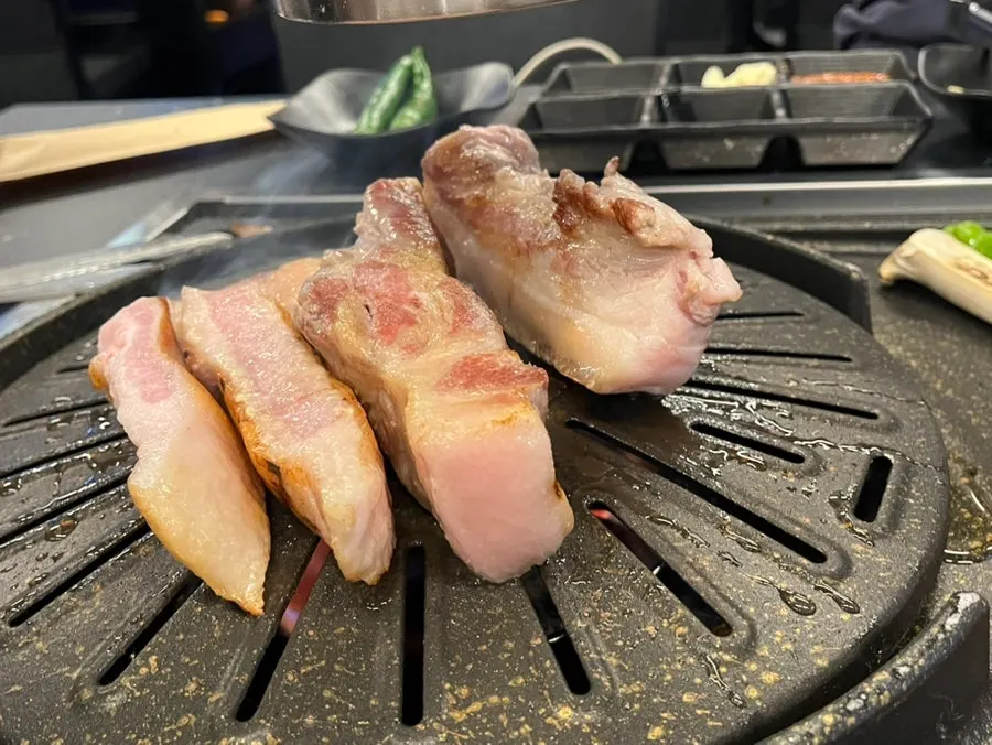 Pork belly cooking through the smoke