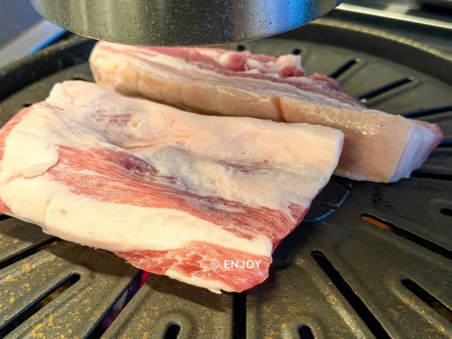 Thick ogyeopsal turning golden brown on the grill