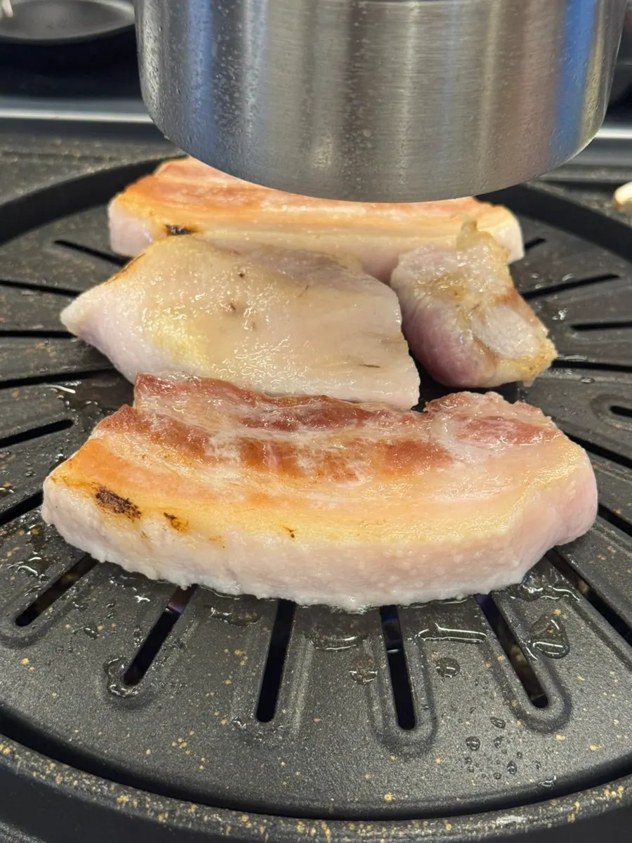 A piece of pork picked up plain, without any dip