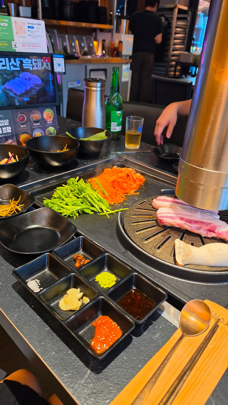 Black pork oergyeopsal grilling on the plate