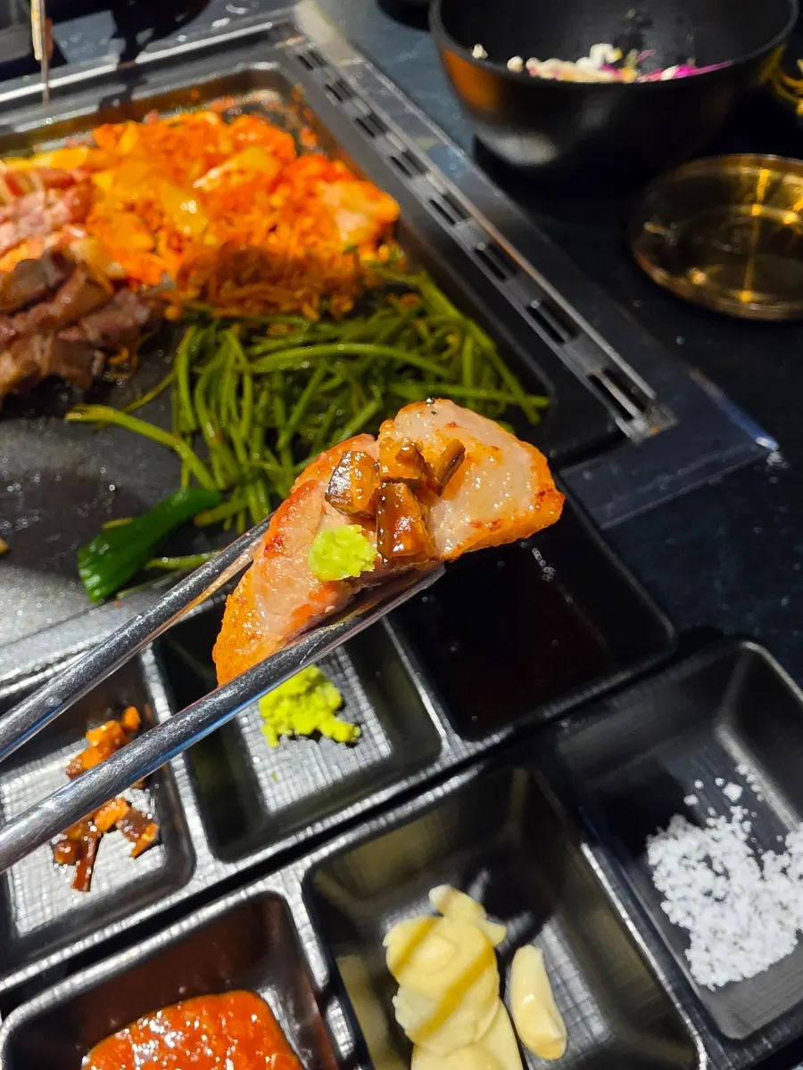 A piece of grilled samgyeopsal with smoky char