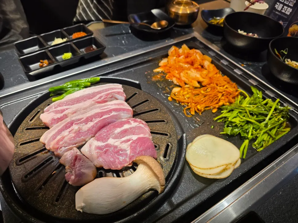 Pork belly on the grill with minari, bean sprouts, and kimchi