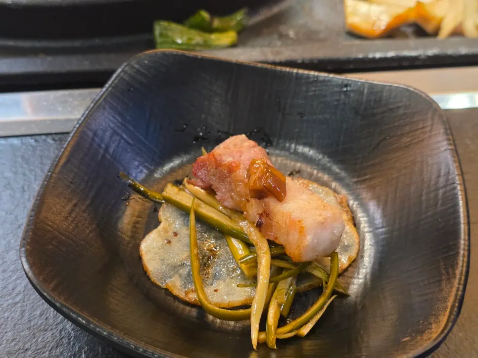 Potato ssam with meat placed on a grilled potato slice