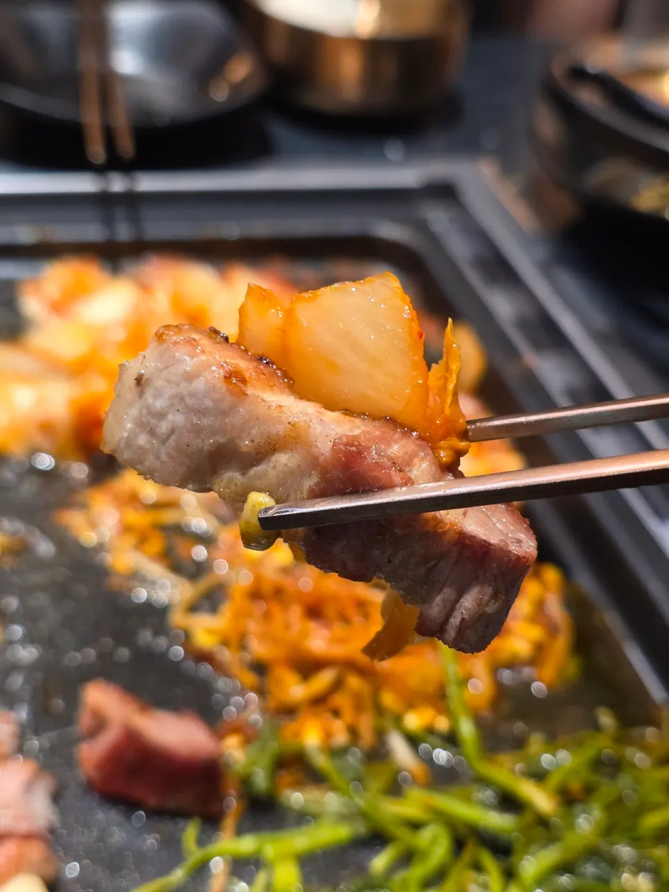Minari and kimchi kept warm on the grill plate