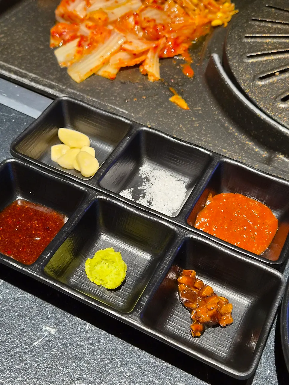 Various sauces served alongside the meat