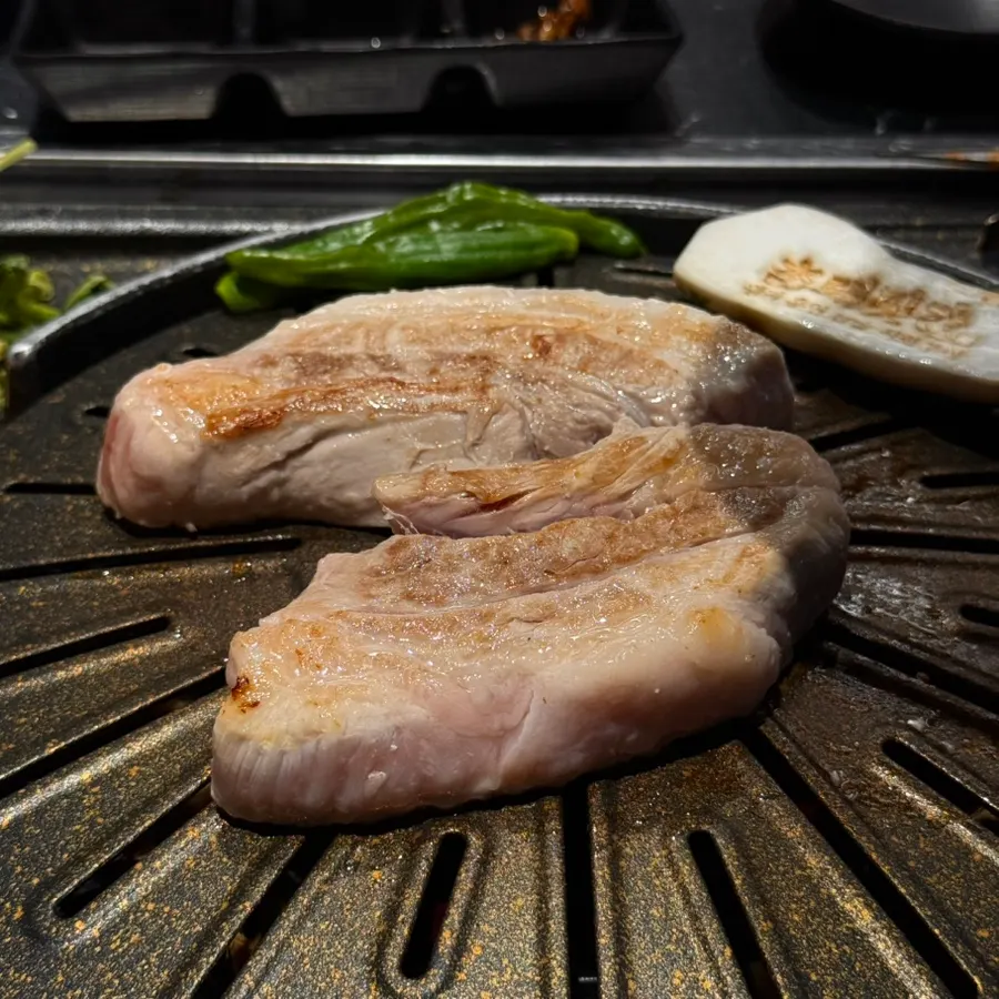 Thick-cut pork belly on the charcoal grill pan