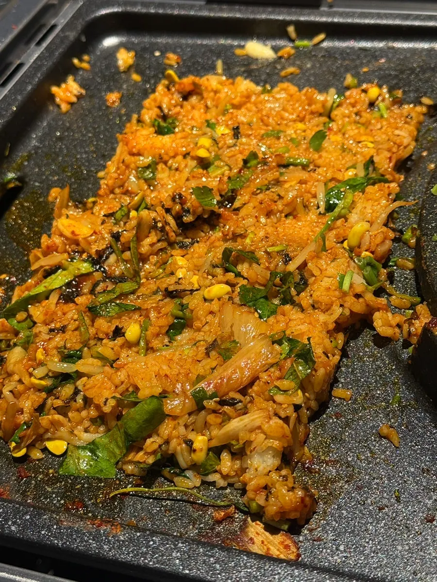 Fried rice being stir-fried on the grill