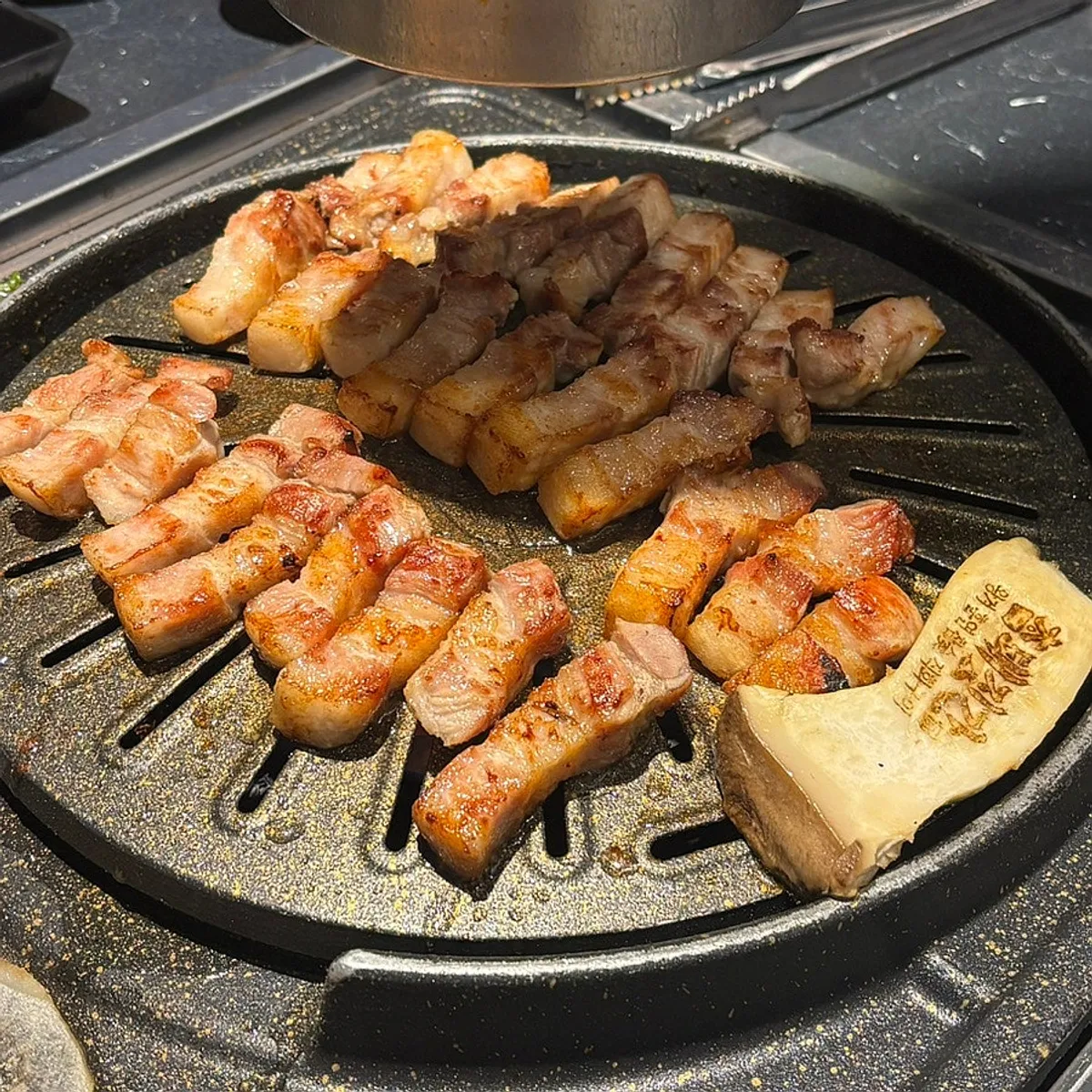Main table spread of pork belly at Cham Dwaejitgan Bucheon Sinjung-dong Branch