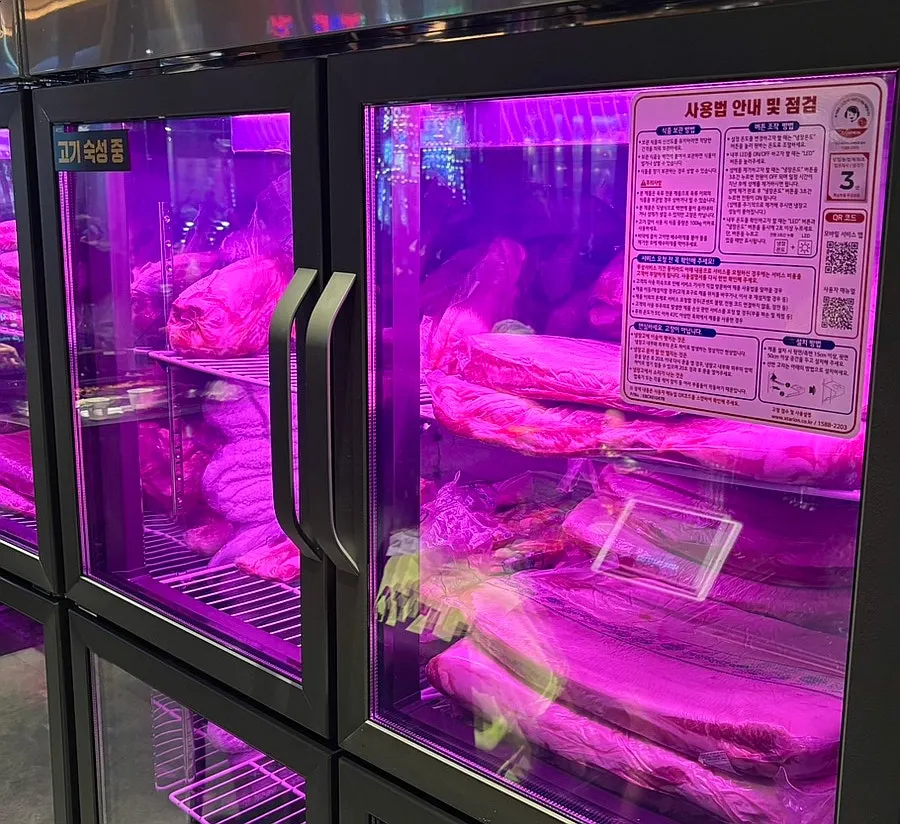 Meat-aging fridge on one side of the store