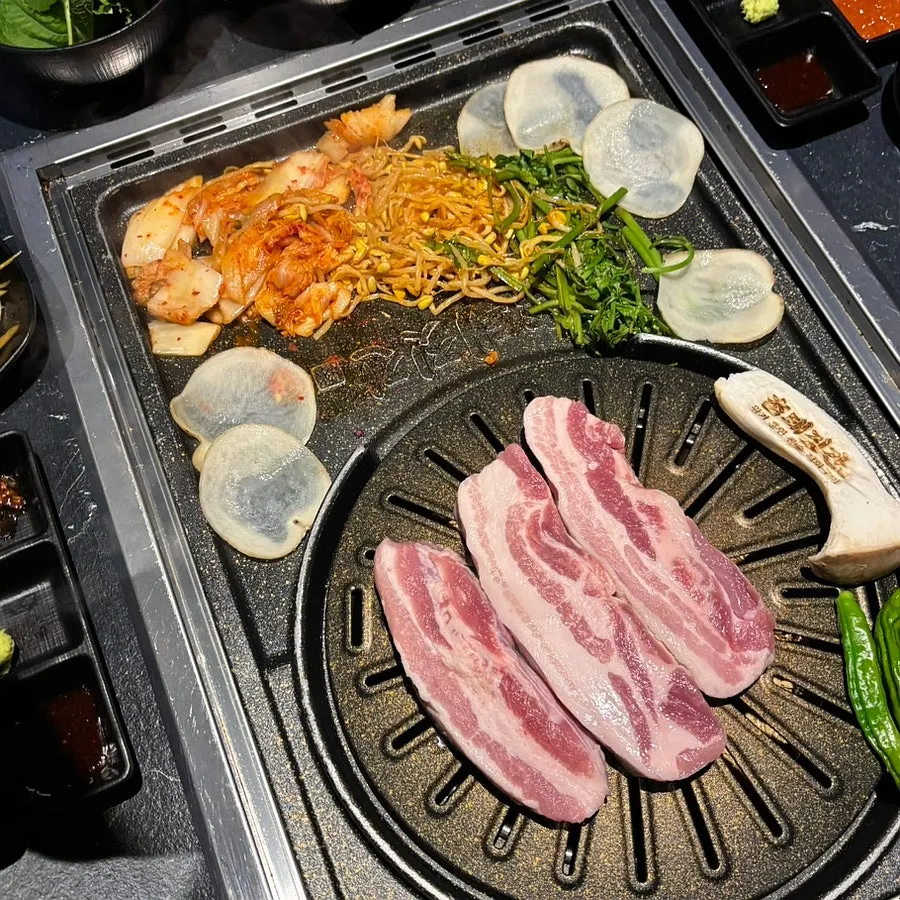 Thick-cut raw Boseong Nokdon pork belly on a plate
