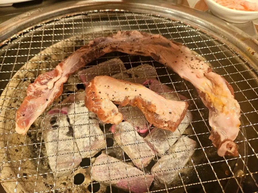 Spicy pork ribs grilling on charcoal