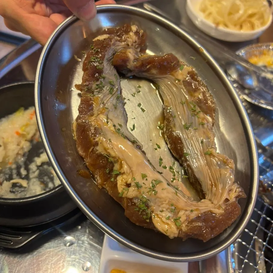Remaining jjokgalbi and side dishes on the grill
