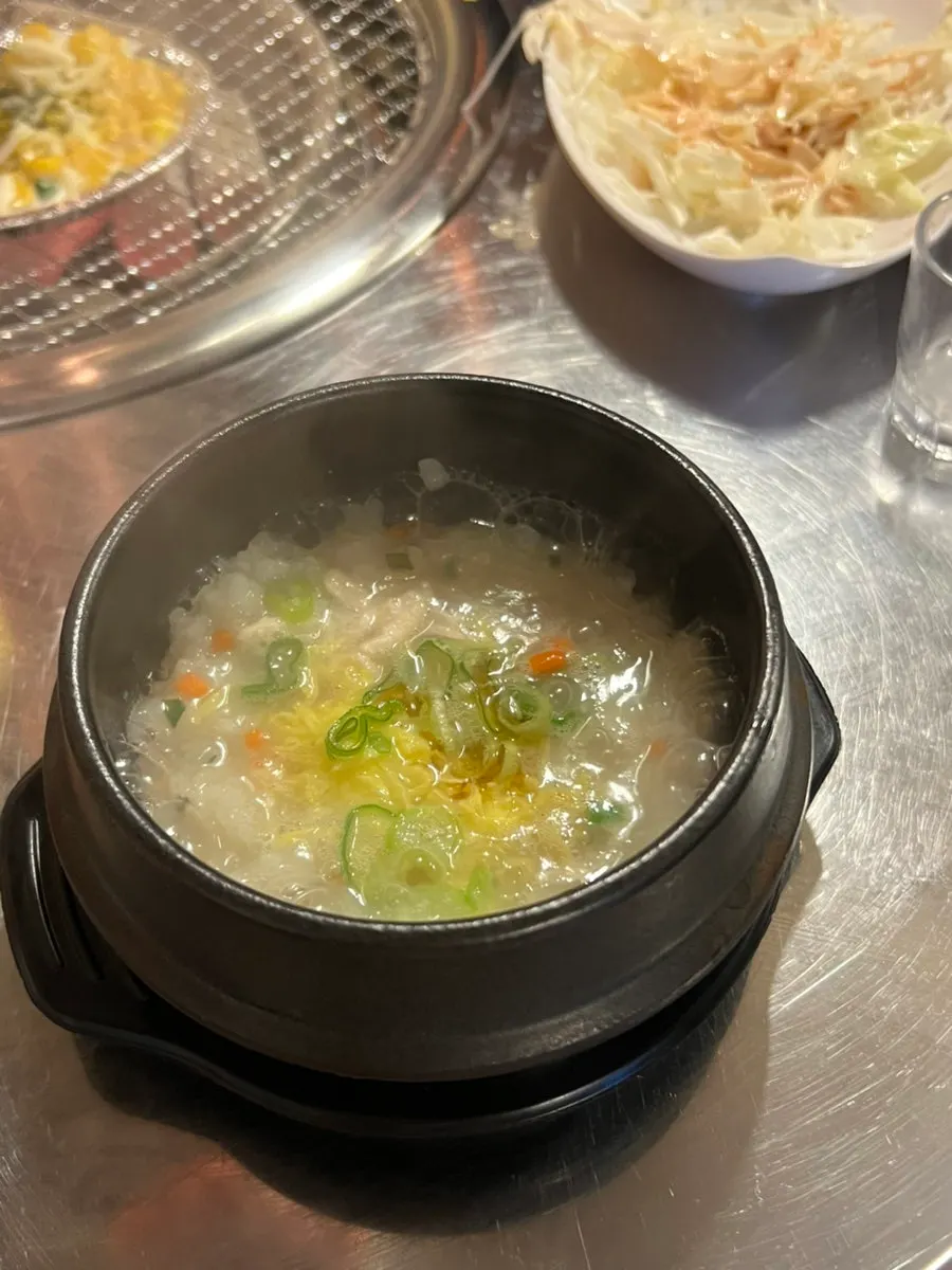 A bowl of free chicken porridge served as a side