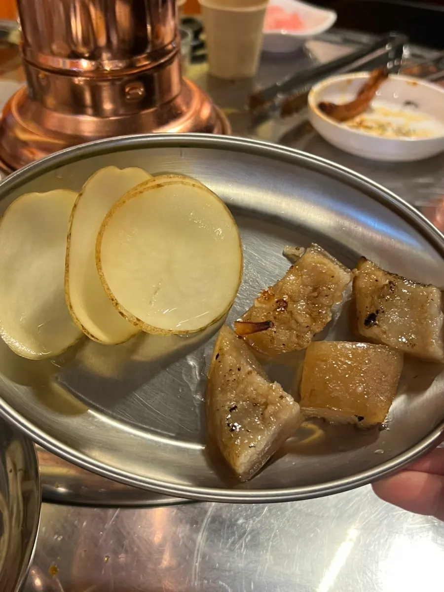 Charcoal-grilled pork skin served as a free side