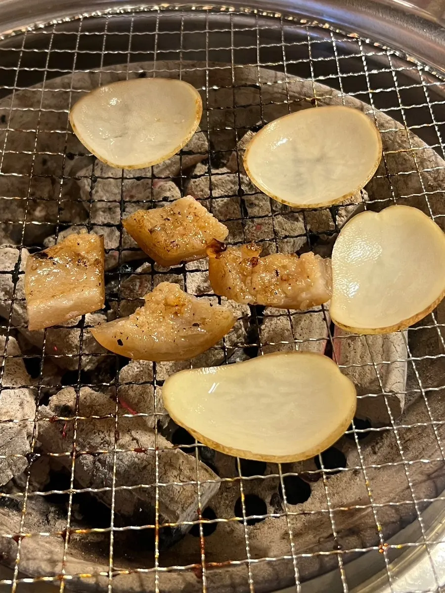 Pork skin and potatoes grilling on the tabletop grill