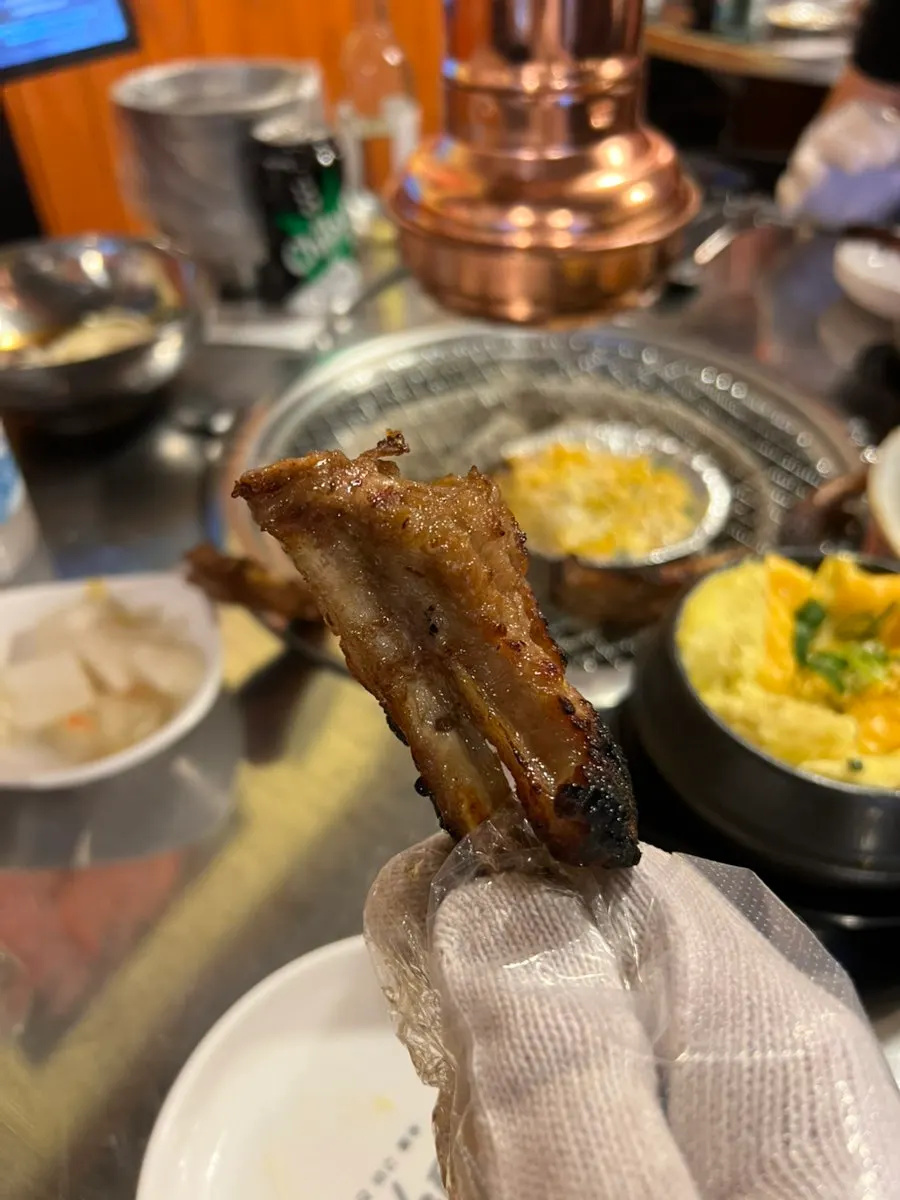 A piece of soy sauce jjokgalbi with bone and meat separated