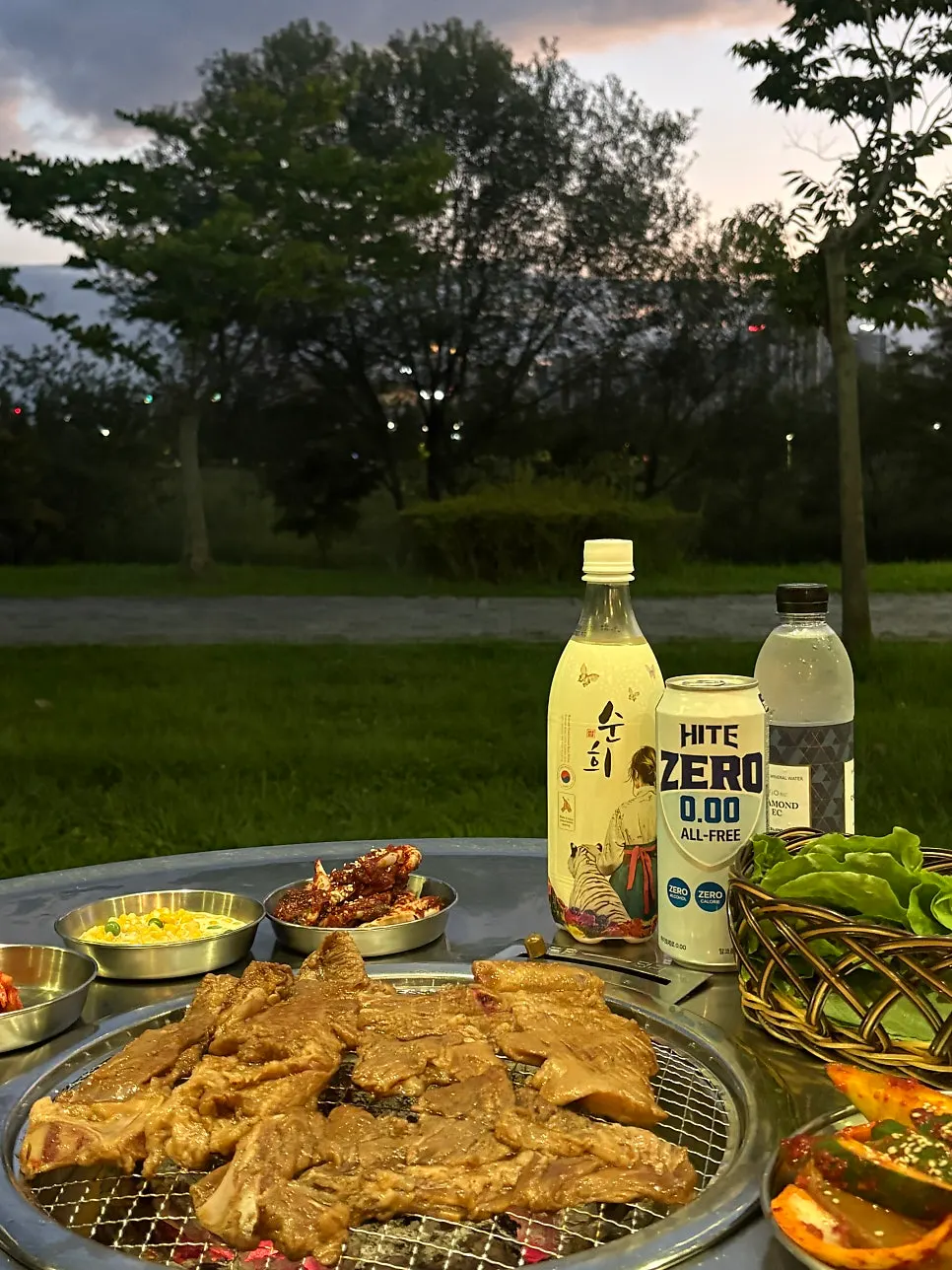 Makgeolli and grilled meat on the outdoor table
